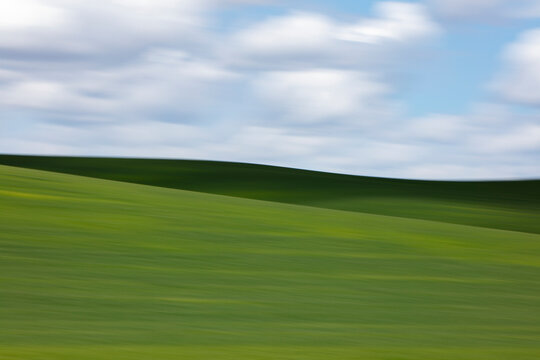 The Palouse, a large fertile agricultural prairie region, green slopes, crops growing on the land.