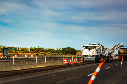Highway construction along Interstate 90 between Vantage and George, work vehicles, tarmac lorries and road mending equipment.