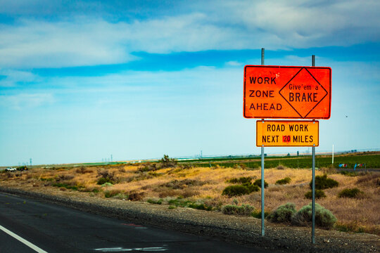 Work zone ahead sign for road work, George, Washington state. Sign saying Give 'em a BRAKE.