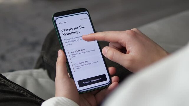Person explores strategic business consulting and CEO mentorship services on a smartphone, highlighting leadership development, scaling challenges and executive decision making.