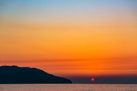 Widfire smoke influenced sun sunset on the Strait of Juan de Fuca, Port Angeles.