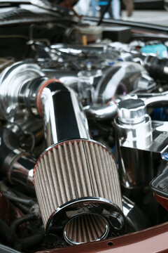 High performance car engine featuring a polished intake system, K&N air filter, and chrome components.
