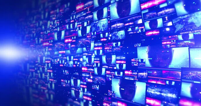 Massive multi display array playing abstract light graphics and futuristic technology animations.