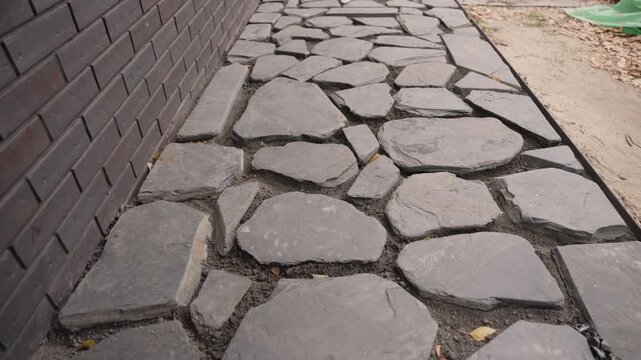 Laying a slate flagstone garden path and filling gaps with crushed stone