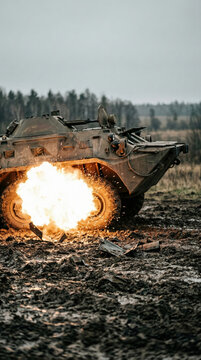 Armored personnel carrier exploding in a muddy field. Military vehicle hit by blast during combat mission. Tragedy of armed conflict and modern global war destruction and violence.