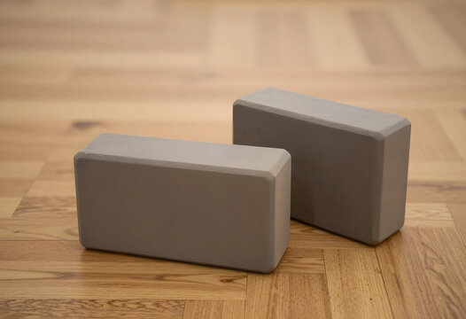 Yoga and mindfulness practice two grey foam blocks on a wooden floor for fitness training meditation and physical therapy exercise at home studio