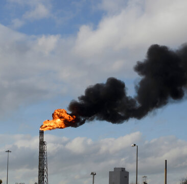 Flare at oile refinery burning off excess hydrocarbon