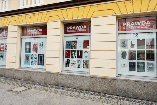 Poster exhibition storefront with PRAWDA displays in Radom, Poland showing graphic artwork in city street windows