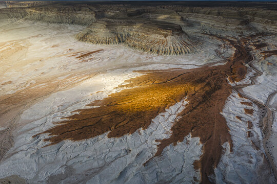 Aerial view of the dramatic white chalk cliffs and eroded landscape of Bozjyra, highlighting the unique geological formations and deep canyons in Aktau, Mangystau Region, Kazakhstan.