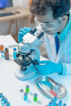 Scientist examining laboratory samples and test tubes for scientific research, analysis, and experimental studies in a modern laboratory.