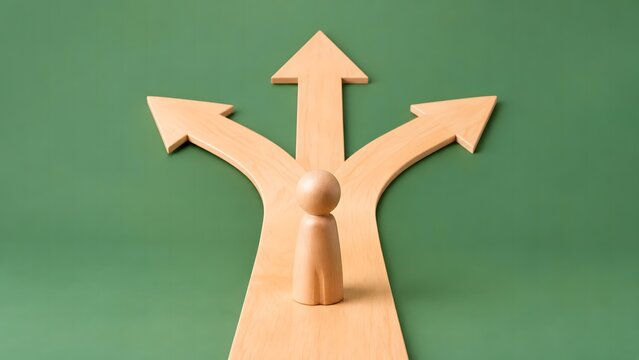 A wooden figure stands at a junction where a path splits into three distinct directions, representing a crucial decision point or a crossroads in life.