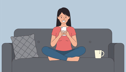 Fototapeta premium Young woman sitting cross-legged on a grey sofa using her smartphone with a pillow and tea cup.