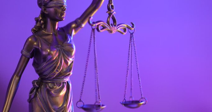 Blindfolded Lady Justice statue holding scales neon light background
