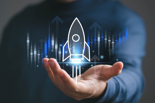 Digital startup growth concept showing a glowing rocket launching above a business skyline from an open hand, symbolizing innovation, entrepreneurship, technology, investment, progress, future success