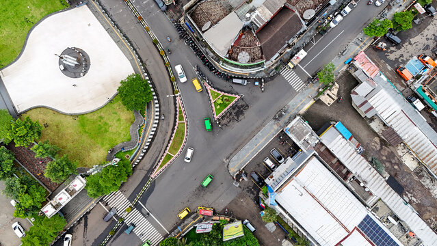 Aerial view of the urban intersection with surrounding buildings, roads, vehicles, and a small park area in Sukabumi, West Java, Indonesia.