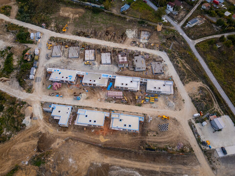 Aerial view of a residential construction site near a forest in the country