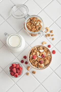 Breakfast ingredients arranged from above on a light tiled background