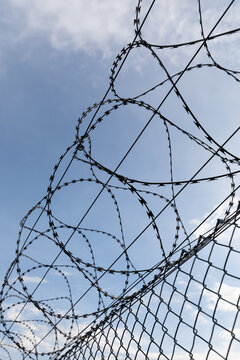 07 October 2026, Razor wire sits atop a perimeter security fence at Stuttgart Airport, Germany.
