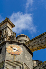 Ancient stone clock tower of Iglesia Mayor Prioral showcasing Gothic architecture against a vibrant blue sky, highlighting historical beauty and architectural details in Spain © photoopus
