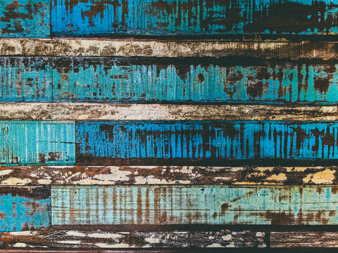 Vintage distressed wooden planks texture with peeling turquoise paint background. Wallpaper of weathered vintage wooden planks with distressed texture. Perfect antique  backdrop for creative design