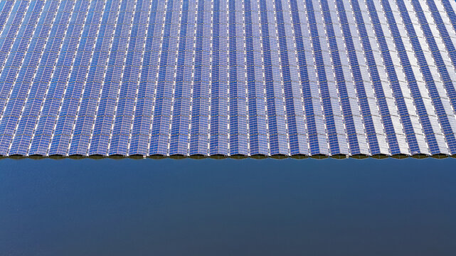 Aerial top-down view of floating solar panels on water