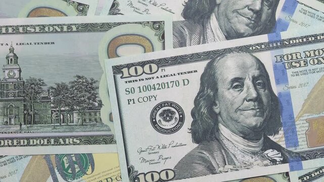 Scattered one hundred us dollar bills in a pile