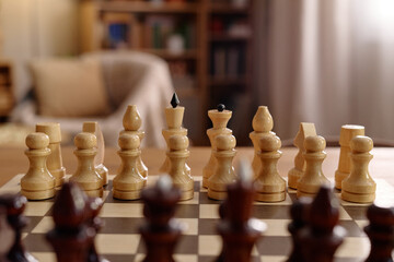 Close up shot of wooden chess pieces arranged on chessboard ready for match. Scene representing strategic planning, competition, cognitive training, suitable for business marketing © Seventyfour