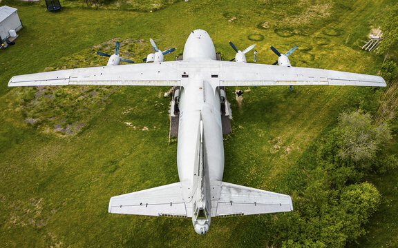 Aerial view of a former sovjet military transport aircraft aircraft parked on a grassy field in Rummu, Laane County, Estonia.