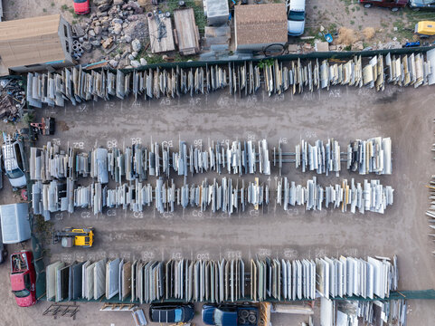 Aerial view of a stone slab and tile storage yard with rows of granite, quartz and marble slabs organized in numbered slots in Eagle, Colorado, United States.