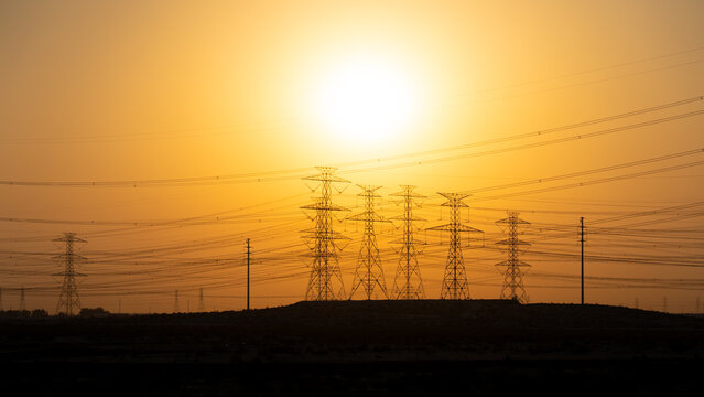 High Voltage Electric Line Transmission Towers and Power Lines in Desert Landscape of Saudi Arabia