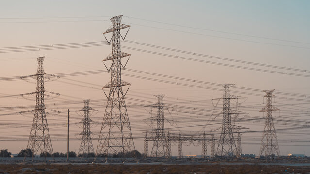 High Voltage Electric Line Transmission Towers and Power Lines in Desert Landscape of Saudi Arabia