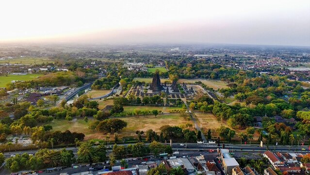 Aerial view of Prambanan Temple surrounded by lush green trees and historic temple grounds in Kecamatan Prambanan, Daerah Istimewa Yogya, Indonesia.