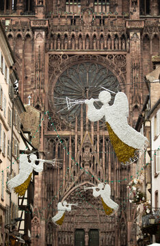 Christmas in Strasbourg, Alsace, France. Illuminated angels with trumpets above a historic street near Strasbourg Cathedral.