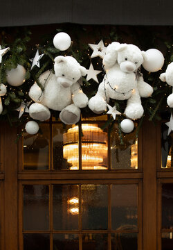 Christmas in Strasbourg, Alsace, France. Cute white teddy bears with Christmas ornaments, evergreen branches and glowing lights