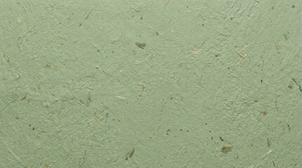 Fototapeta premium Light green handmade paper texture with visible organic fibers and recycled material particles for artistic backgrounds