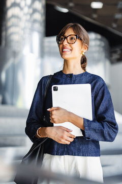 Businesswoman Holding Tablet in Modern Office Building
