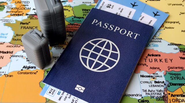 Two suitcases on a map representing the concept of travel, emigration, or air travel