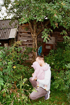 Parent and child explore in a garden setting
