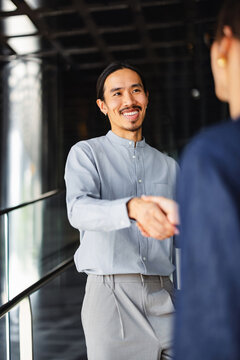 Business Meeting With Handshake in Front of Modern Office Building