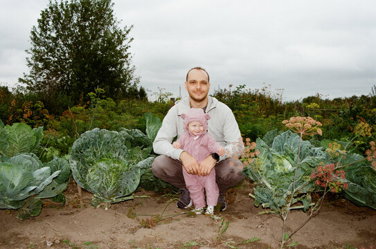 Father and daughter in a vegetable garden