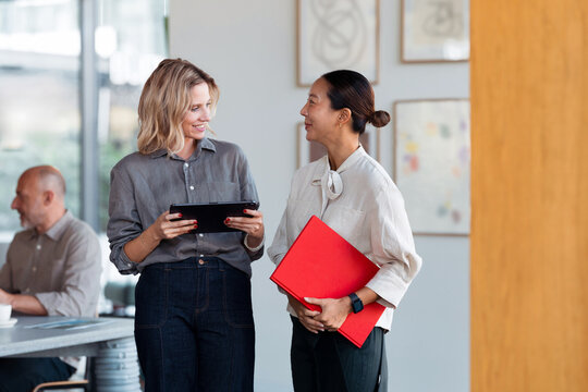Business Colleagues Talking in Modern Office Workspace