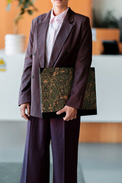 Professional Woman Holding Portfolio In Office Reception