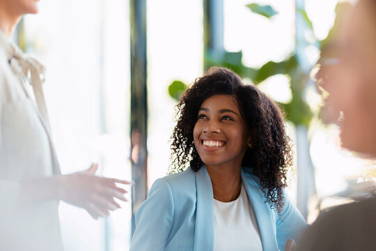 Smiling Businesswoman Engaged In Office Team Meeting