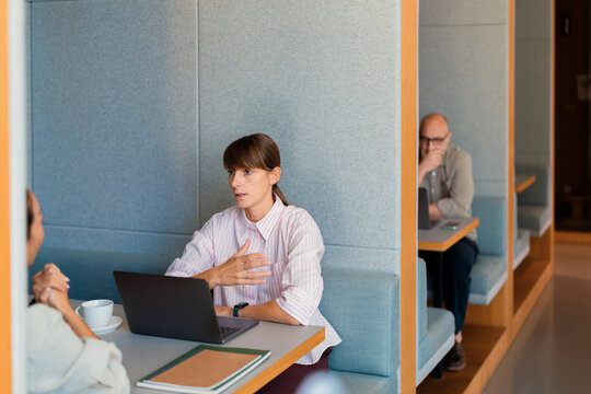 Business Meeting in Modern Office Booth With Laptop