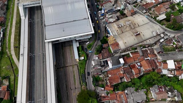 Aerial view of Stasiun Kereta Cepat Padalarang with modern railway tracks and nearby residential buildings in Padalarang, West Java, Indonesia.