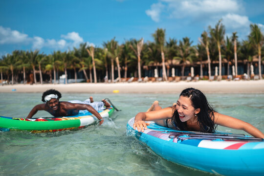 Luxury beach resort vacation with young couple, tourist enjoying water activities on summer vacation