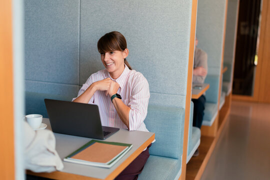 Smiling Businesswoman Working Remotely at Laptop