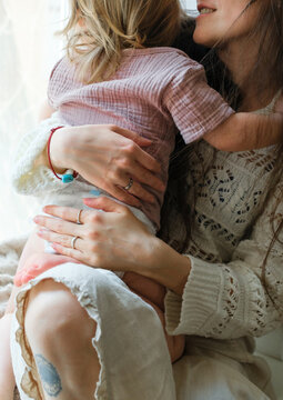 Close-up of a mother hugging her young child in a tender moment