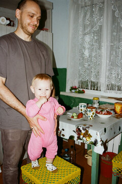 Man and child interact in a kitchen setting
