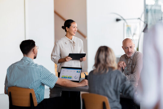 Business Team Meeting With Presentation In Modern Office